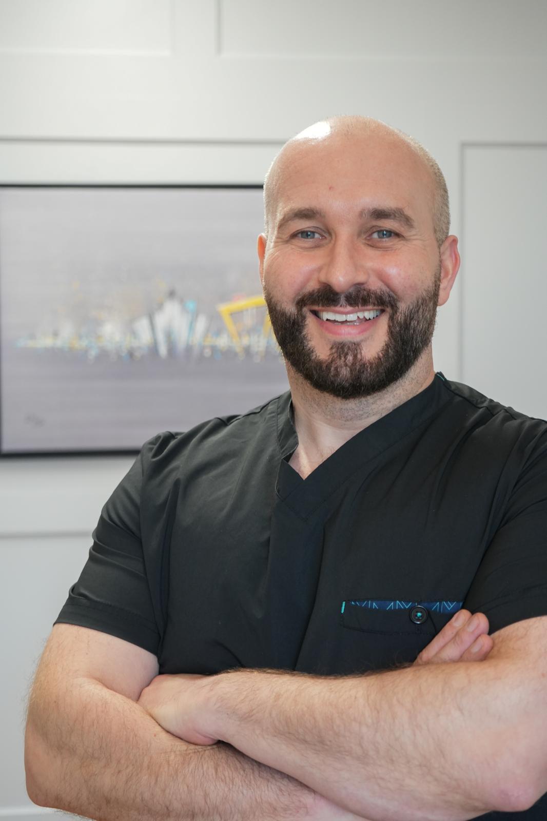 Dr Cormac Lynch, founder of Smart Aesthetics Academy, in clinic scrubs